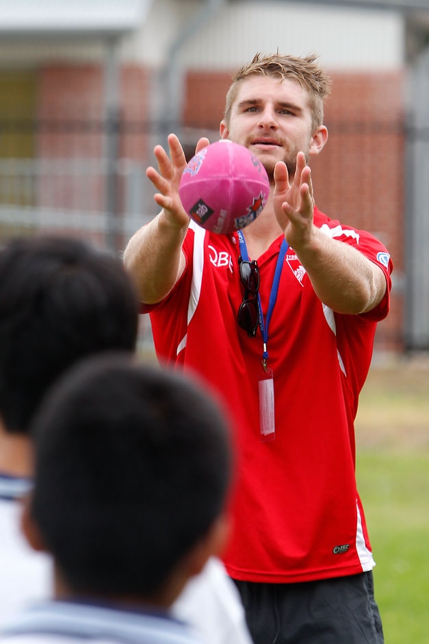 AFL 2014 Media - Sydney Swans Community Camp Harry Marsh of the Swans catches a pass from students during the Australia Post Sydney Swans Community Camp in Sydney on February 11, 2014. (Photo: Anthony Pearse/AFL Media)